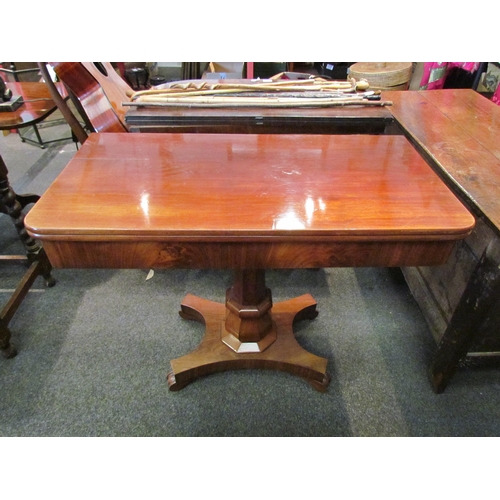 1145 - A Victorian flame mahogany tea table, the fold-over top over a faceted column to a quatreform base