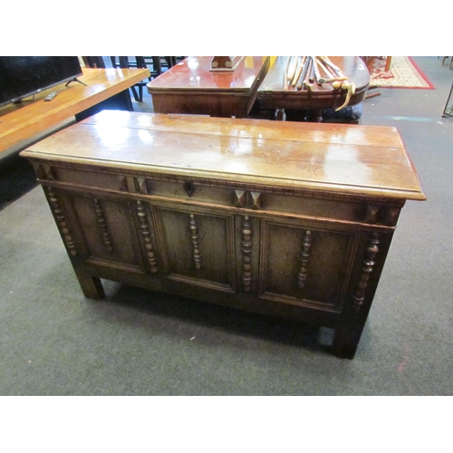 1148 - An 18th Century country oak coffer, three panel front with applied spindle detail, stile legs, 67cm ... 