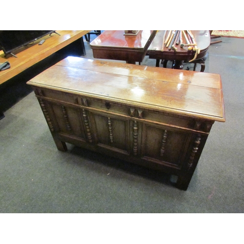 1148 - An 18th Century country oak coffer, three panel front with applied spindle detail, stile legs, 67cm ... 