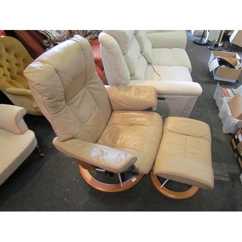 1183 - A 'Stressless' leather swivel chair with matching footstool, a/f wear present