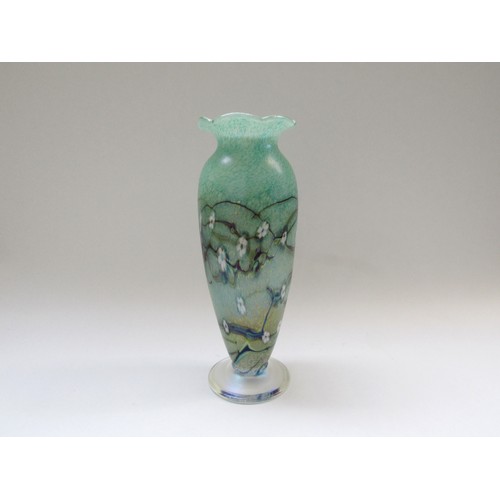 9138 - An Okra Glass vase in green with white flowers, iridescent foot.  Signed by Richard Golding to base.... 