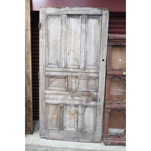 2082 - A 19th Century oak eight panel door 224 x 109cms