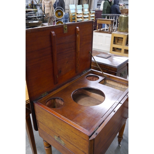 2231 - A 19th Century mahogany campaign table with unscrewable legs, the top lifts to reveal a washstand