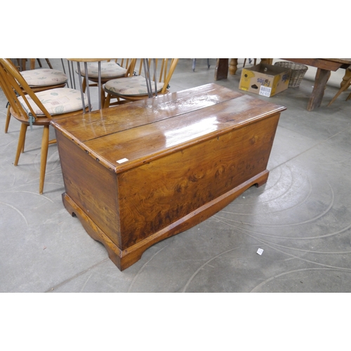 2235 - A Georgian country elm blanket box, shaped plinth base