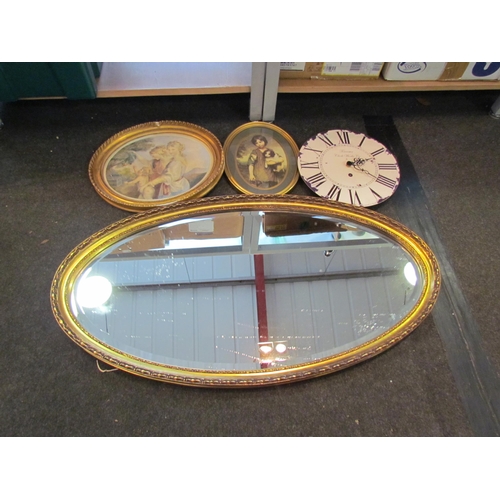 1197 - A gilt oval wall mirror, two prints and a battery operated wall clock together with three candle hol... 