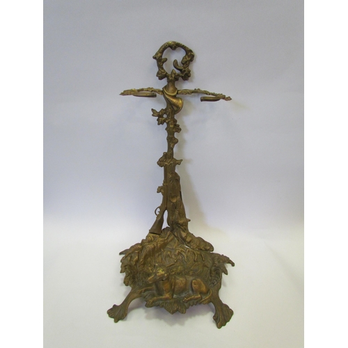 1227 - A brass fireside companion with gun and dog design along with associated attachments, 56cm tall