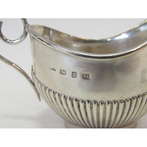 1324 - A Victorian silver cream jug, fluted detail, scrolled handle, London 1897