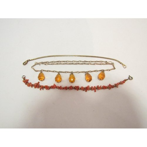 1337 - A coral rough cut bracelet interspersed with brass beads, a yellow metal flat link bracelet and an a... 