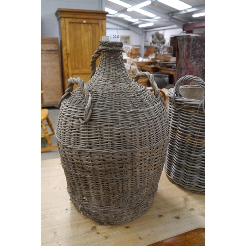 2249 - A early 20th century wicker covered wine carbuoy