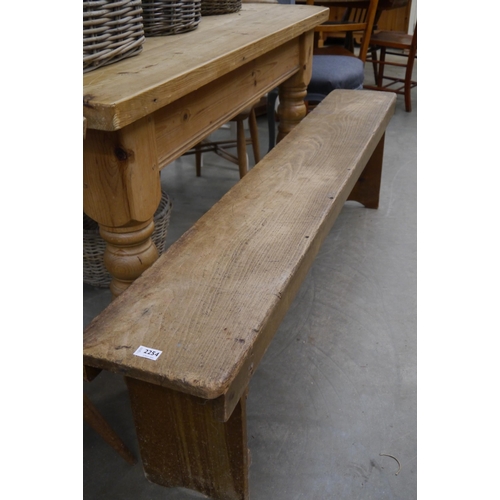 2254 - A rustic pine bench 182cms long, worm to legs