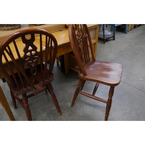 2258 - A pair of wheel back kitchen chairs