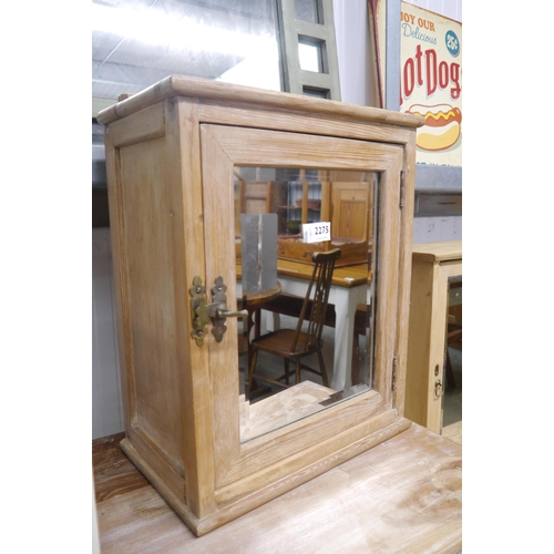 2275 - A stripped pine bathroom cabinet with bevel mirror plate door