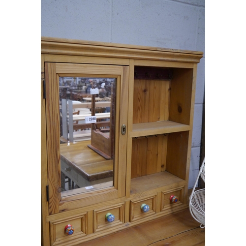 2288 - A pine kitchen cabinet, single mirrored door, single shelf over four drawers