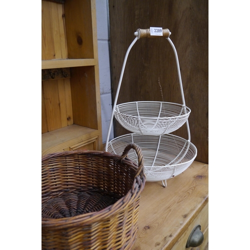 2289 - A circular wicker twin handled basket and a two tier vegetable basket