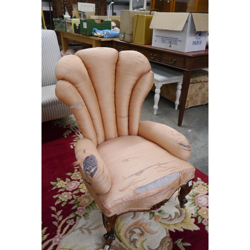 2318 - A Victorian walnut armchair, serpentine front, on scrolled legs to porcelain castors