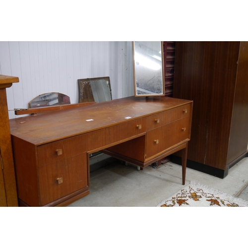 2345 - A 1960's teak dressing table with mirror back and drawer frieze