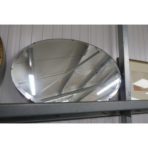 2116 - An Art Deco oval wall mirror with bevelled edge