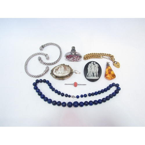 1362 - A lapis lazuli bead necklace, two cameo brooches, two white metal cuff bangles with dog's head termi... 