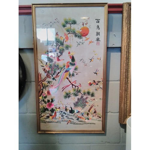 1101 - An Oriental silk picture of birds and foliage, gilt framed and glazed, 83cm x 43cm image size