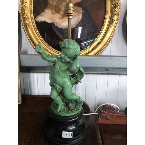 2111 - A green painted cherub lamp