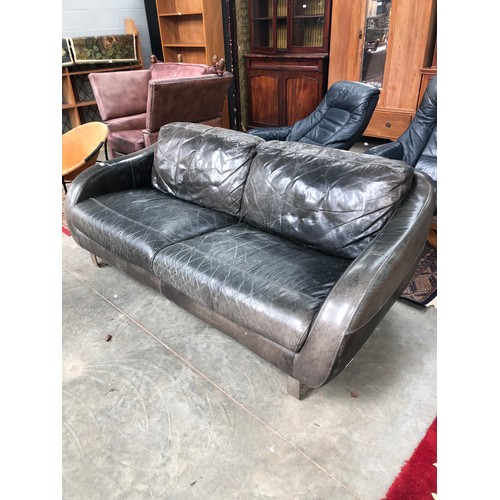 2309 - A worn green leather two seater sofa on chrome legs