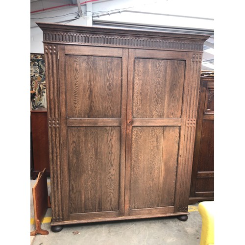 2377 - A large oak two door wardrobe