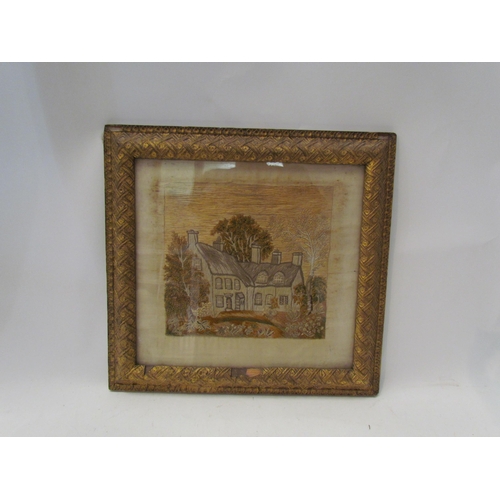 1437 - A 19th Century stumpwork silk embroidery of thatched cottages, framed and glazed, 18cm x 19cm image ... 