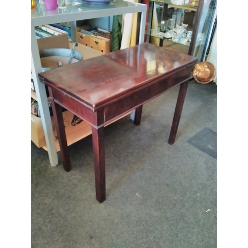 1527 - A 19th Century flame mahogany tea table, the rectangular fold-over top over a plain freize, on squar... 