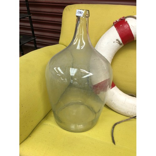 2381 - A large clear glass wine bottle