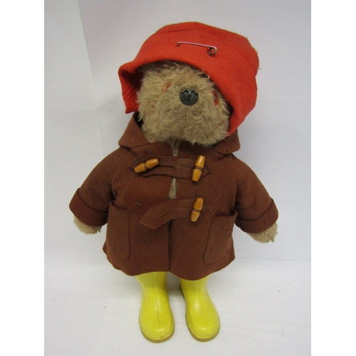 8286 - A vintage Gabrielle Designs Paddington Bear in original brown duffle coat, red hat and yellow wellin... 