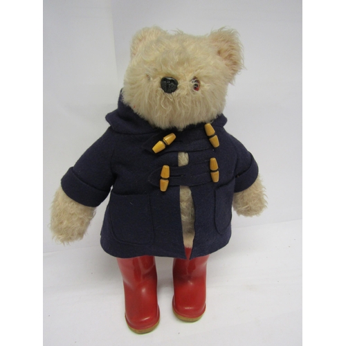 8285 - A vintage Gabrielle Designs Paddington Bear in original dark blue duffle coat and red wellington boo... 