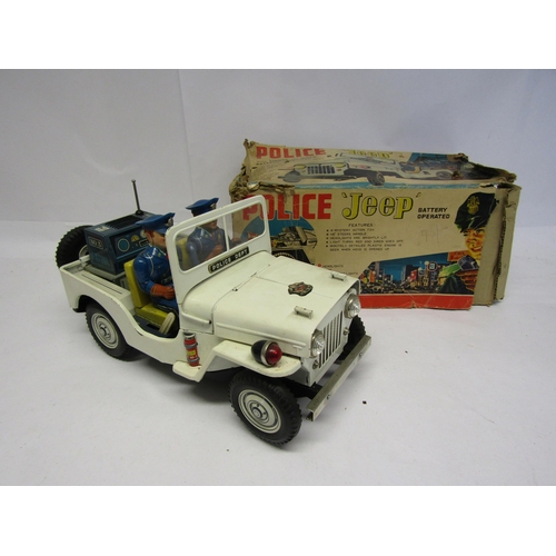 8246 - A Nomura TN (Japan) battery operated tinplate Police Jeep, the white Jeep with folding windscreen, p... 