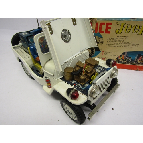 8246 - A Nomura TN (Japan) battery operated tinplate Police Jeep, the white Jeep with folding windscreen, p... 