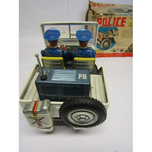 8246 - A Nomura TN (Japan) battery operated tinplate Police Jeep, the white Jeep with folding windscreen, p... 