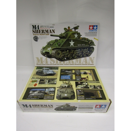 8411 - A boxed Tamiya 1/16 scale radio control M4 Sherman 105mm Howitzer model tank kit with 2-channel oper... 