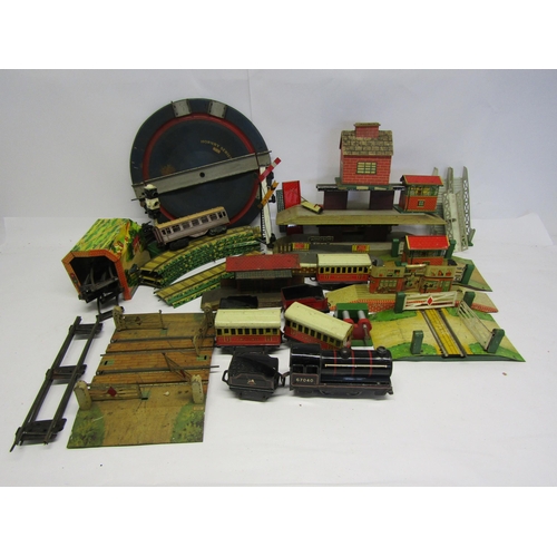 8455 - A collection of playworn 0 gauge model railway rolling stock, accessories and spares including Wells... 