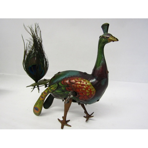 8238 - An early 20th Century litho printed tinplate clockwork peacock novelty toy