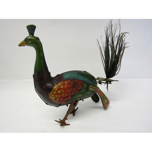 8238 - An early 20th Century litho printed tinplate clockwork peacock novelty toy