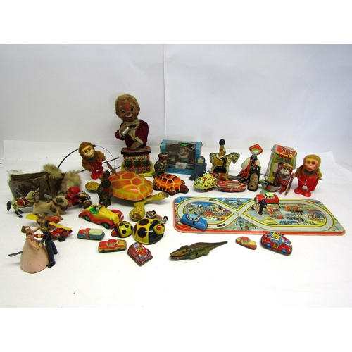 8343 - A collection of mostly playworn tinplate and mechanical novelty toys and vehicles including English ... 