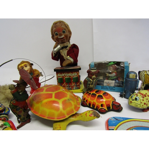 8343 - A collection of mostly playworn tinplate and mechanical novelty toys and vehicles including English ... 