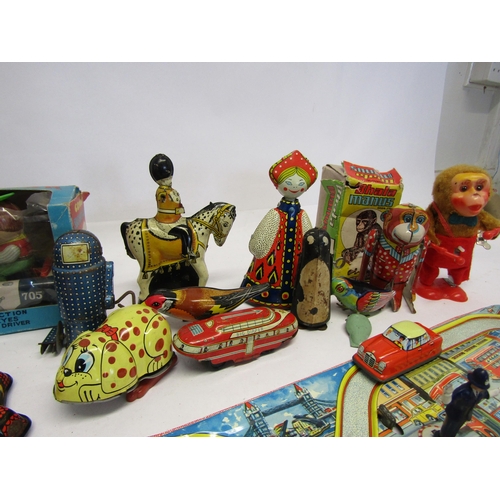 8343 - A collection of mostly playworn tinplate and mechanical novelty toys and vehicles including English ... 