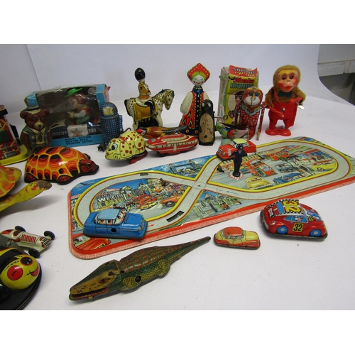 8343 - A collection of mostly playworn tinplate and mechanical novelty toys and vehicles including English ... 