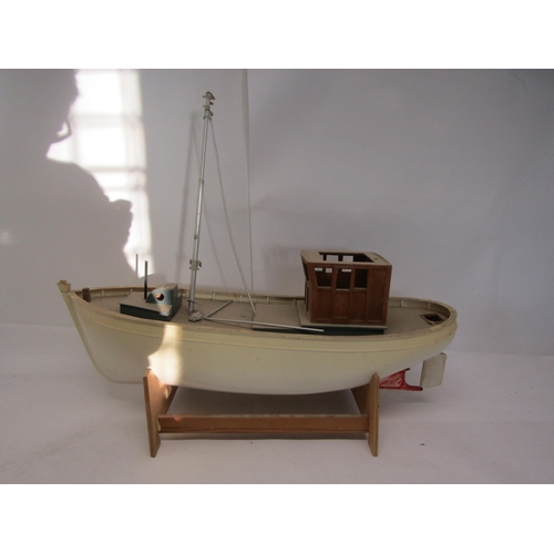 8436 - An unfinished kit built model boat with plastic hull and wooden deck, on stand, 73cm long