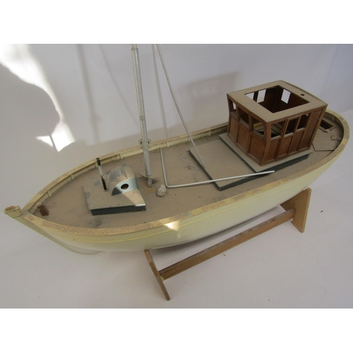 8436 - An unfinished kit built model boat with plastic hull and wooden deck, on stand, 73cm long