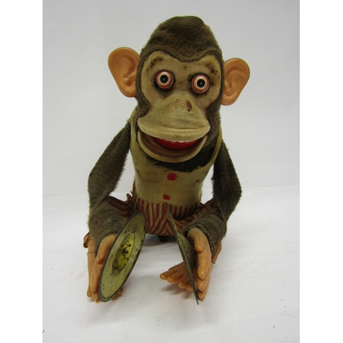 8333 - A Kuramochi (Japan) fabric covered tinplate battery operated clapping monkey with cymbals, 23cm tall... 