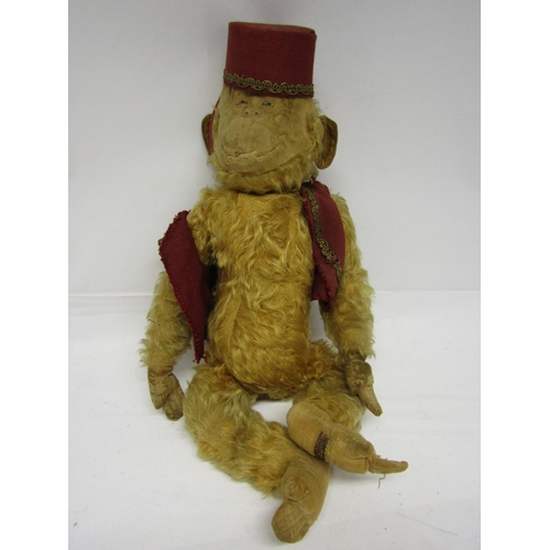 8289 - A Merrythought careworn soft filled golden mohair monkey with moulded cloth face, felt ears, hands a... 