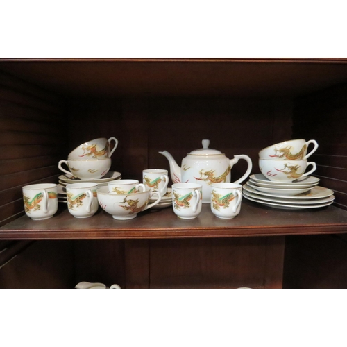 4092 - A quantity of 20th Century Japanese eggshell tea ware, dragon design enriched with gilt