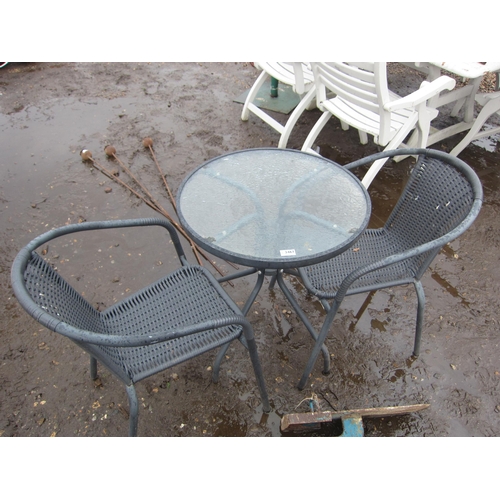 3467 - A wicker effect glass top garden table with two chairs