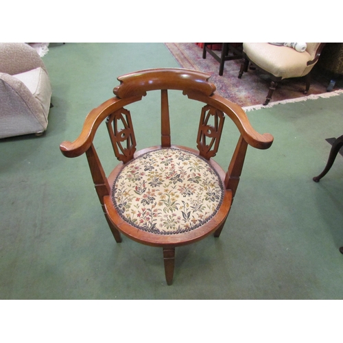 4070 - A 1930's oak tub chair, fretwork supports and foliate and studwork upholstery