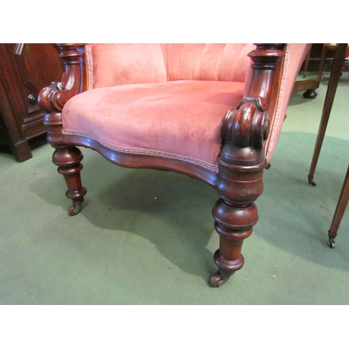 4074 - Circa 1850 a carved mahogany button back rest salmon pink upholstery library armchair, the scroll ca... 